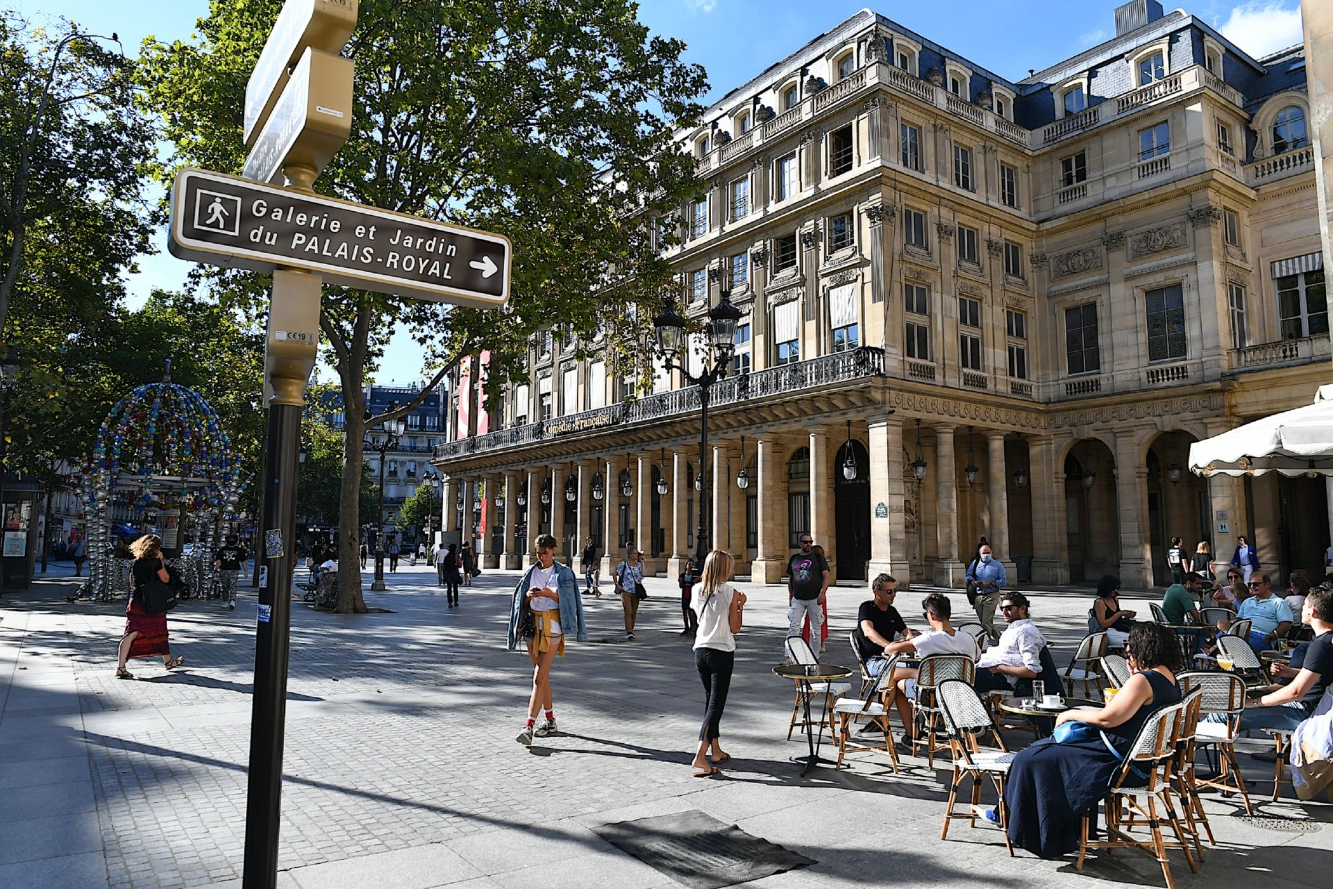 Paris, France-08 04 2020:People seated at a cafÃ© terrace in the Place Colette in Paris facing the Comedie-Francaise theater.The Place Colette is a square which is bordered by the Palais-Royal and the ComÃ©die-FranÃ§aise.