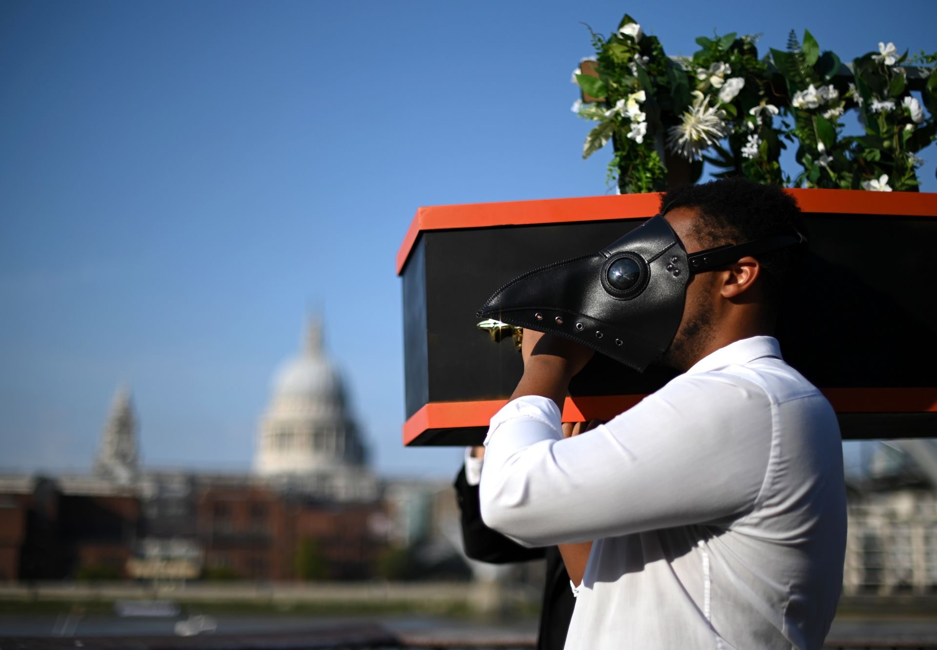 Musicians perform a staged funeral for the "death" of live music, during a socially-distanced photocall performance for One Night Records' forthcoming 'Lockdown Town' production, on the banks of the River Thames in London on September 16, 2020. - One Night Records' is set to open an immersive live music experience called 'Lockdown Town', near London Bridge in London on October 2, 2020. (Photo by DANIEL LEAL-OLIVAS / AFP)