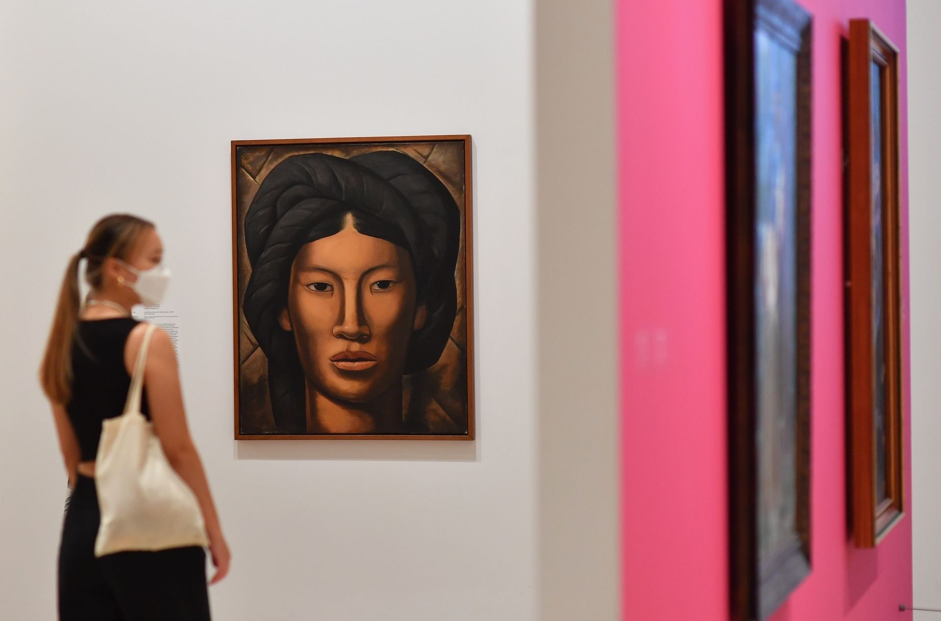 A visitor looks at art work while looking through an exhibition at the newly reopened Whitney Museum of American Art on September 3, 2020 in New York City. - The museum officially opened to the public with new safety guidelines after being closed for months due to covid-19. (Photo by Angela Weiss / AFP)
