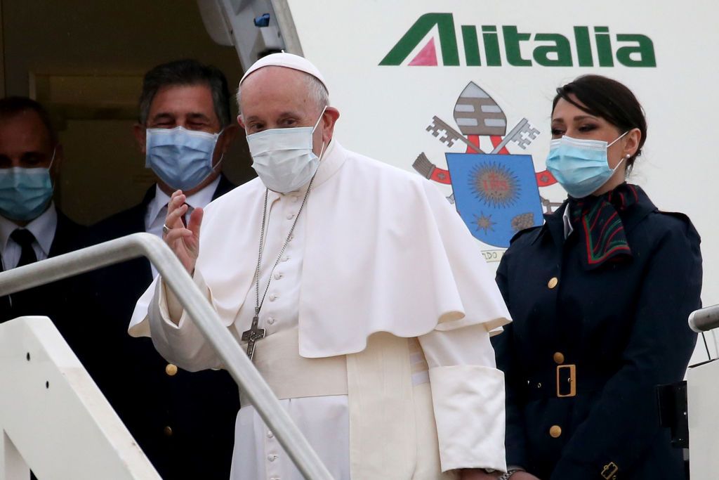 ROME, ITALY - MARCH 05: Pope Francis waves as he departs for his trip to Iraq from Leonardo Da Vinci airport on March 05, 2021 in Rome, Italy. Pope Francis will start the historic first ever papal visit to Iraq. In his first foreign trip since the start of the pandemic Pope Francis will visit Baghdad, Najaf, Erbil and the cities of Qaraqosh and Mosul, which were heavily destroyed by ISIS. Although the trip is seen as an act of solidarity, the Vatican has been forced to defend the decision to go ahead with