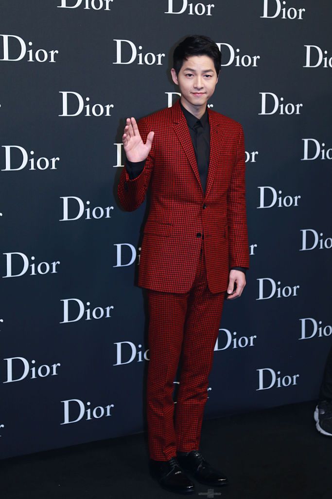 A vision in red; Song Joong Ki attends the Dior Homme Fashion Show - Menswear Collection Winter 2016-17 on 22 April 2016 in Hong Kong, China. | Photo by Visual China Group via Getty Images/Visual China Group via Getty Images