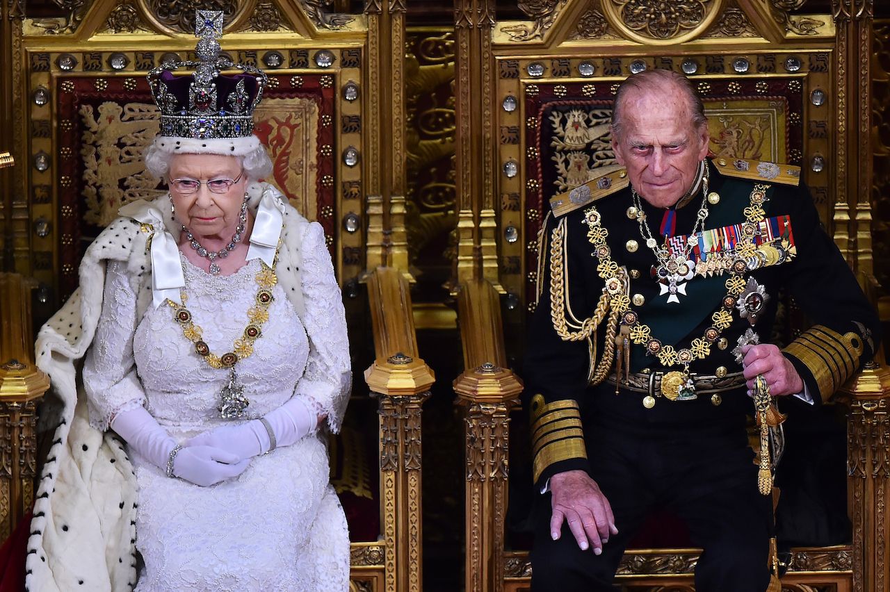 Britain's Queen Elizabeth II (L) prepares to deliver the Queen's Speech from the throne in the House of Lords next to Prince Philip, Duke of Edinburgh (R) during the State Opening of Parliament at the Palace of Westminster in London on May 27, 2015. The State Opening of Parliament marks the formal start of the parliamentary year and the Queen's Speech sets out the governmentâs agenda for the coming session. AFP PHOTO / POOL / BEN STANSALL