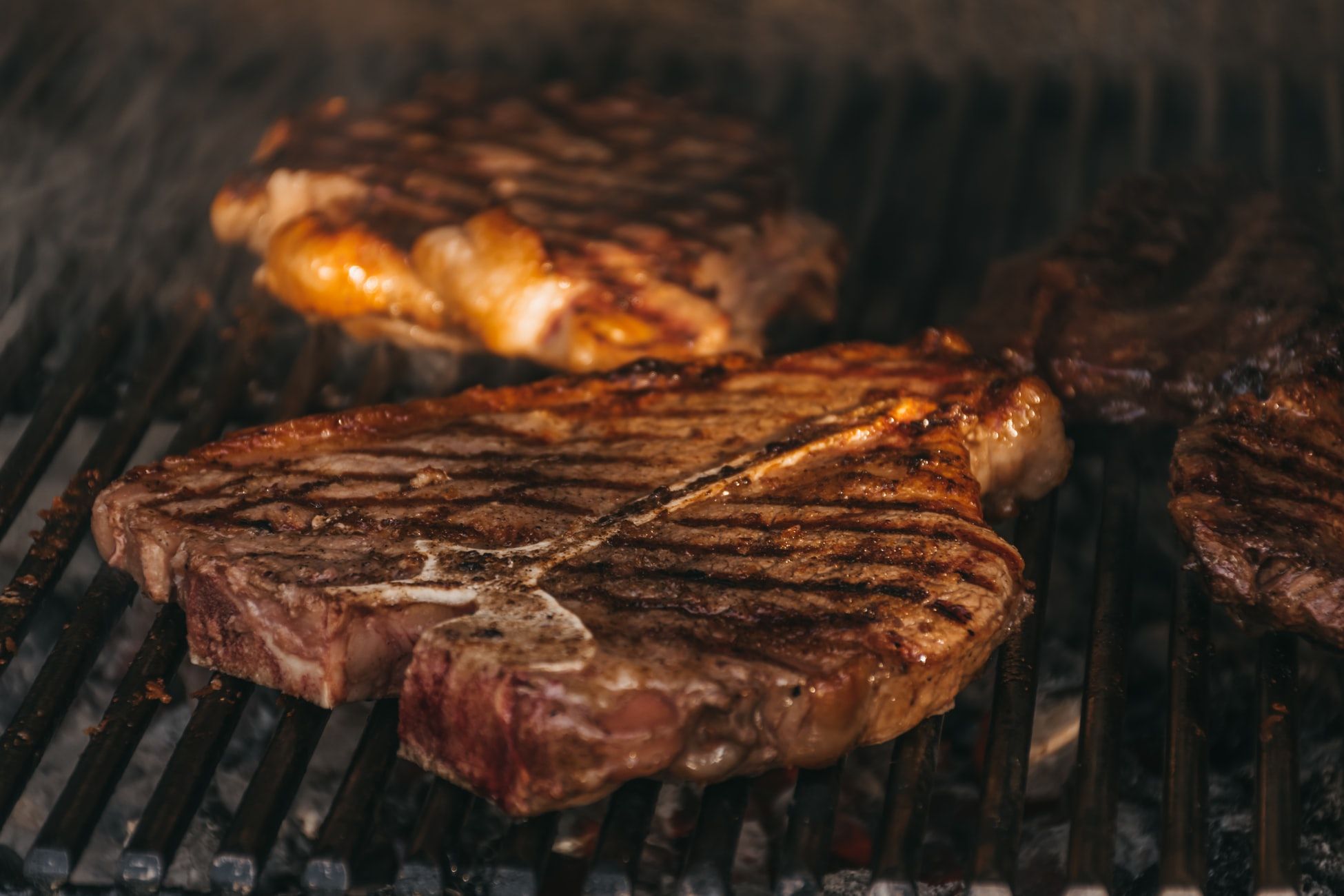 Beautifully grilled steaks atop a charcoal grill. Hitesh Dewasi \ Unsplash