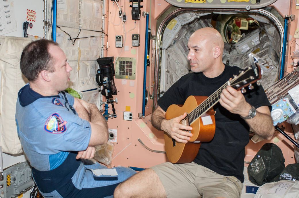 European Space Agency astronaut Luca Parmitano, Expedition 36 flight engineer, plays a guitar in the Unity node of the International Space Station. Russian cosmonaut Alexander Misurkin, flight engineer, is at left. | Photo: NASA