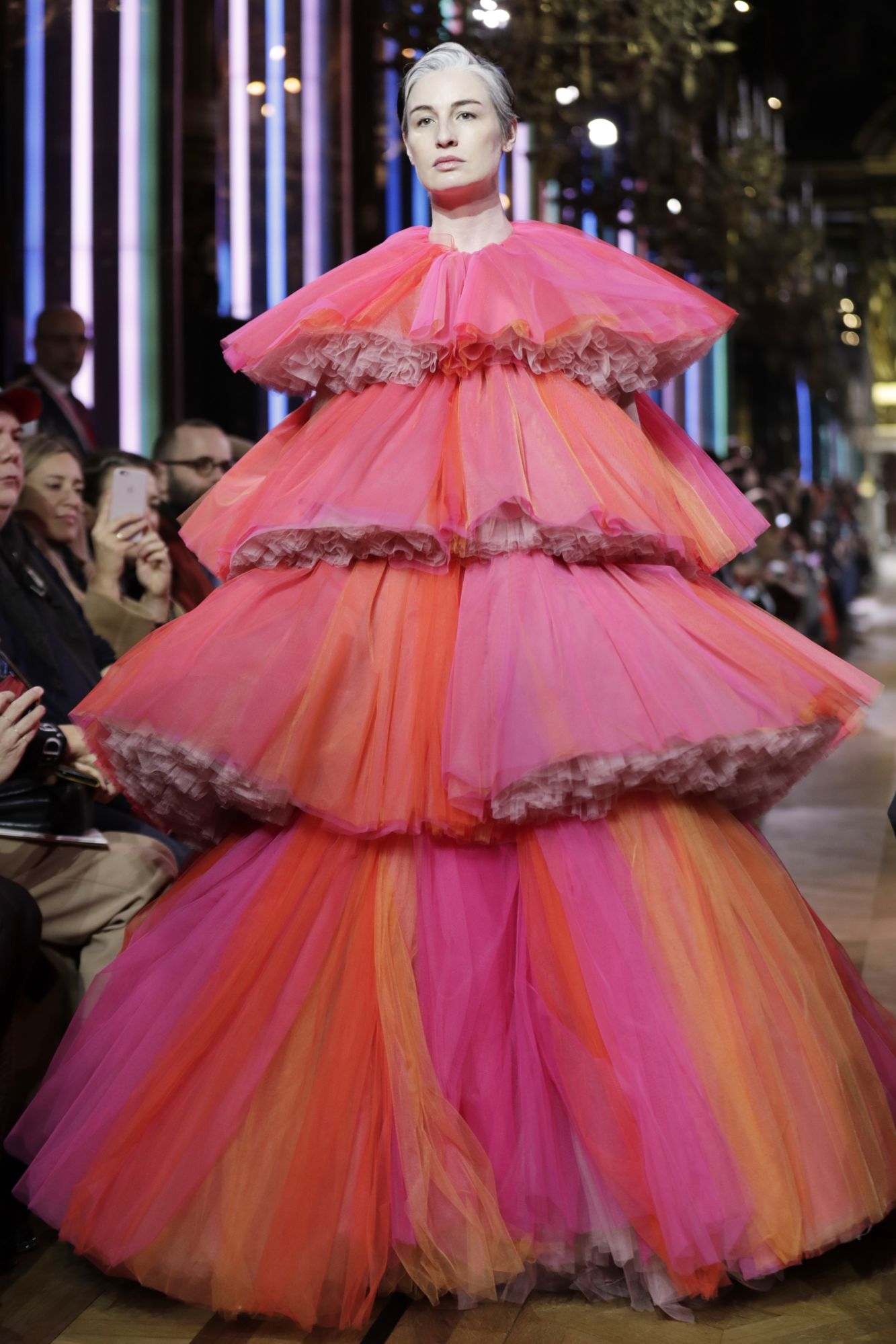 Highly colorful with touches of shocking pink, models strode the runway at Schiaparelli in imposing dresses with multiple flounces, suggestive of enormous flower arrangements. Paris, January 21, 2019; Image: Courtesy of Thomas Samson/AFP
