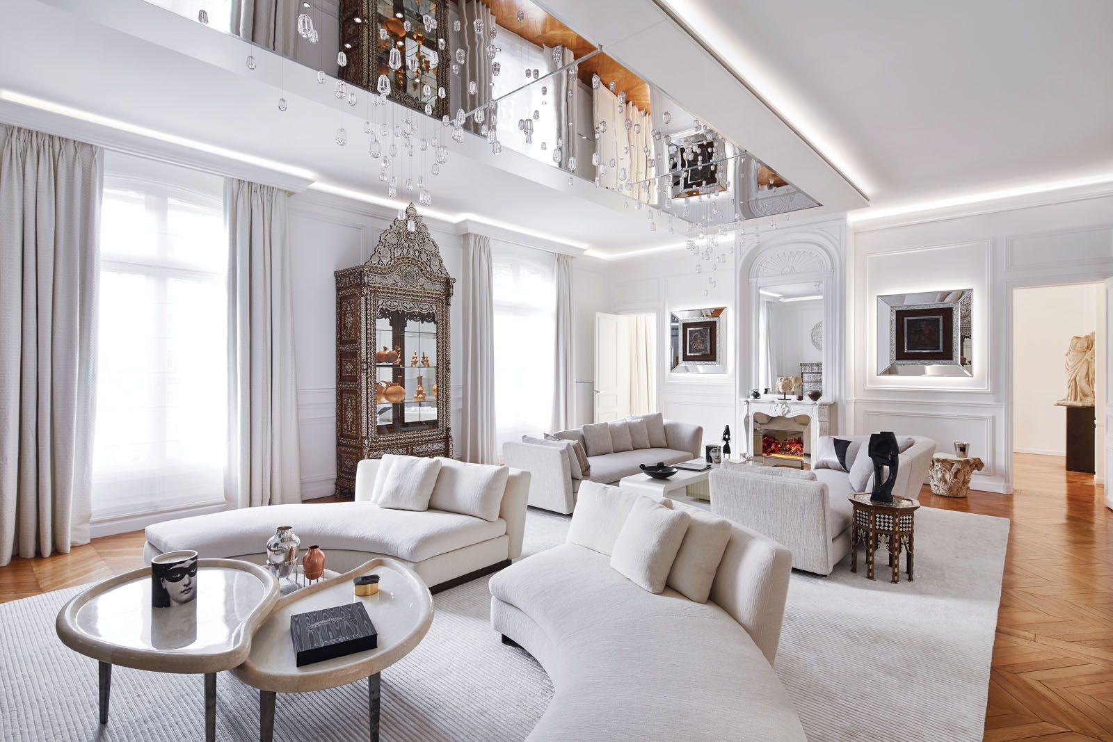 A light palette lets the art and antiques become the stars of the living area