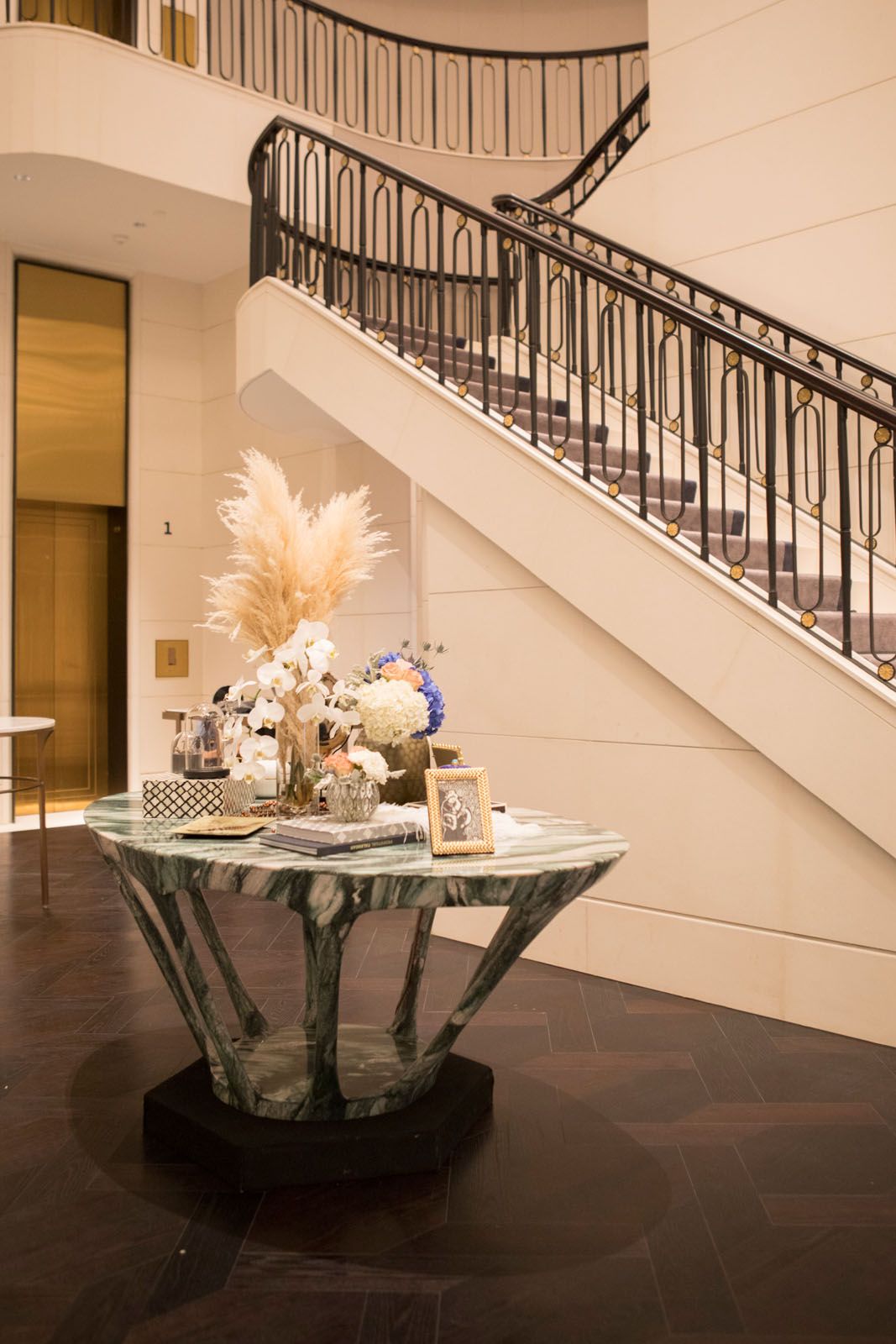 Accessories from Strange & Deranged and floral arrangement by Beato, displayed on the Hive marble table from MM Galleri