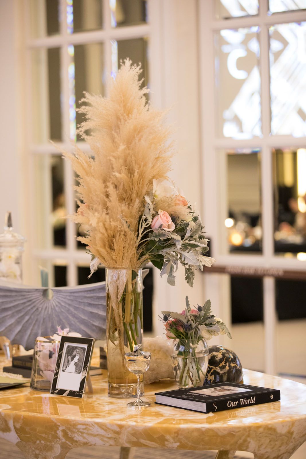 Accessories from Strange & Deranged and floral arrangement by Beato, displayed on the Hive onyx table from MM Galleri
