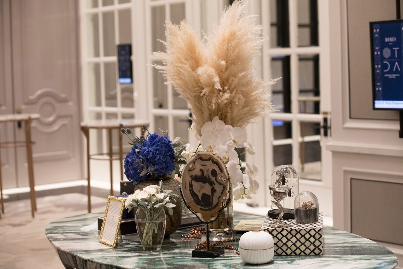 Accessories from Strange & Deranged and floral arrangement by Beato, displayed on the Hive marble table from MM Galleri