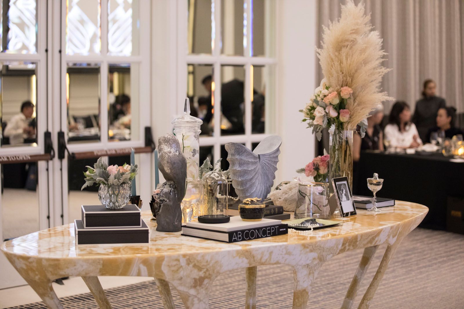 Accessories from Strange & Deranged and floral arrangement by Beato, displayed on the Hive marble table from MM Galleri