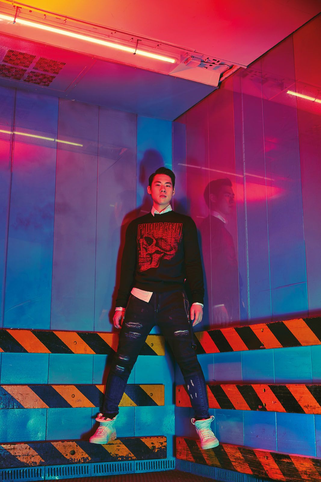 Ken wears printed cotton pullover, cotton shirt, distressed denim jeans and leather high-tops with paint splatter details