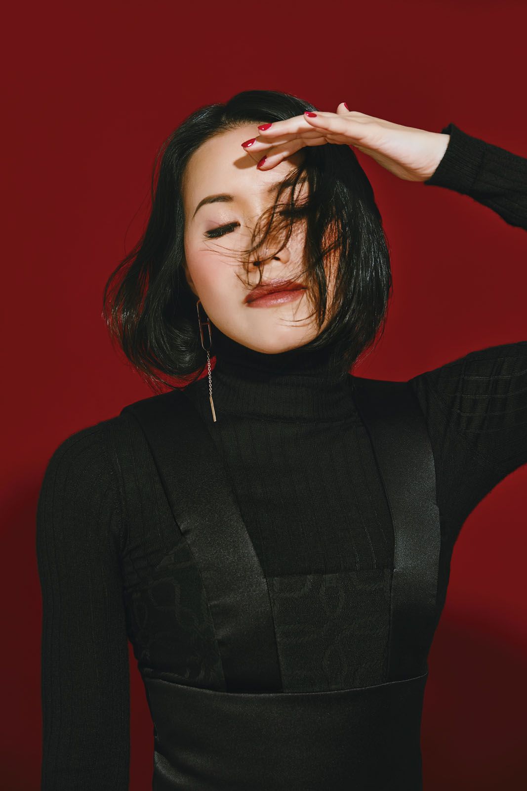 Amanda wears turtleneck by Dior; dress and earring by Hermès