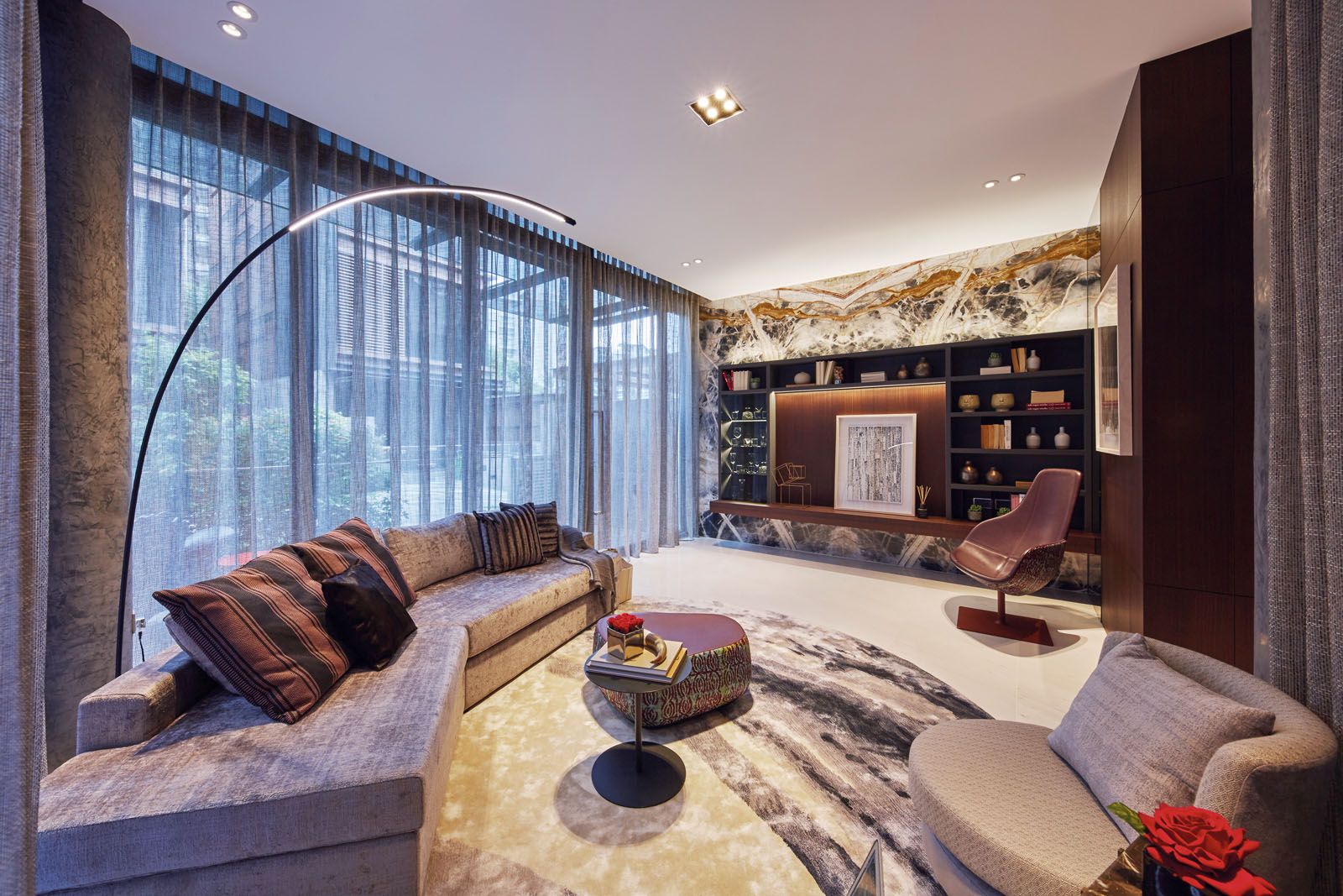 The striking veins of the onyx feature wall create an arresting focal point in the living room