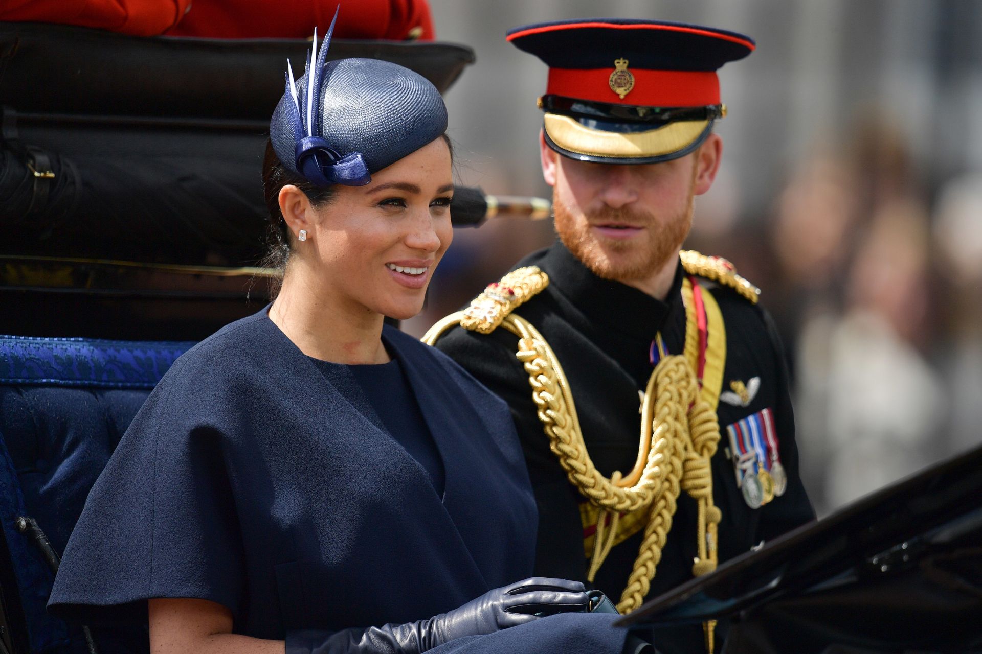 Britain's Meghan, Duchess of Sussex (L) and Britain's Prince Harry, Duke of Sussex (R) return to Buckingham Palace after the Queen's Birthday Parade, 'Trooping the Colour', in London on June 8, 2019. - The ceremony of Trooping the Colour is believed to have first been performed during the reign of King Charles II. Since 1748, the Trooping of the Colour has marked the official birthday of the British Sovereign. Over 1400 parading soldiers, almost 300 horses and 400 musicians take part in the event. (Photo by