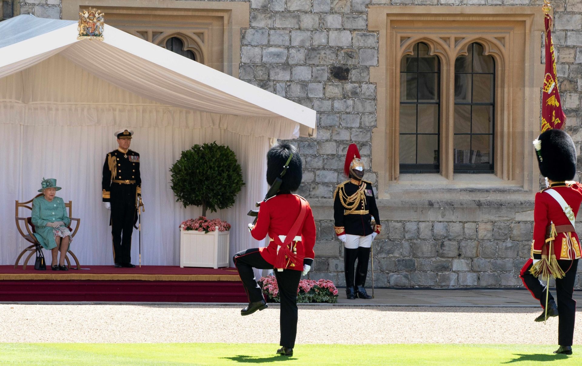 Britain's Queen Elizabeth watches members of the 1st Batallion Welsh Guards perform the Trooping of the Colour during a ceremony to mark her official birthday at Windsor Castle in Windsor, southeast England on June 13, 2020, as Britain's Queen Elizabeth II celebrates her 94th birthday this year. (Photo by Paul Edwards / POOL / AFP)