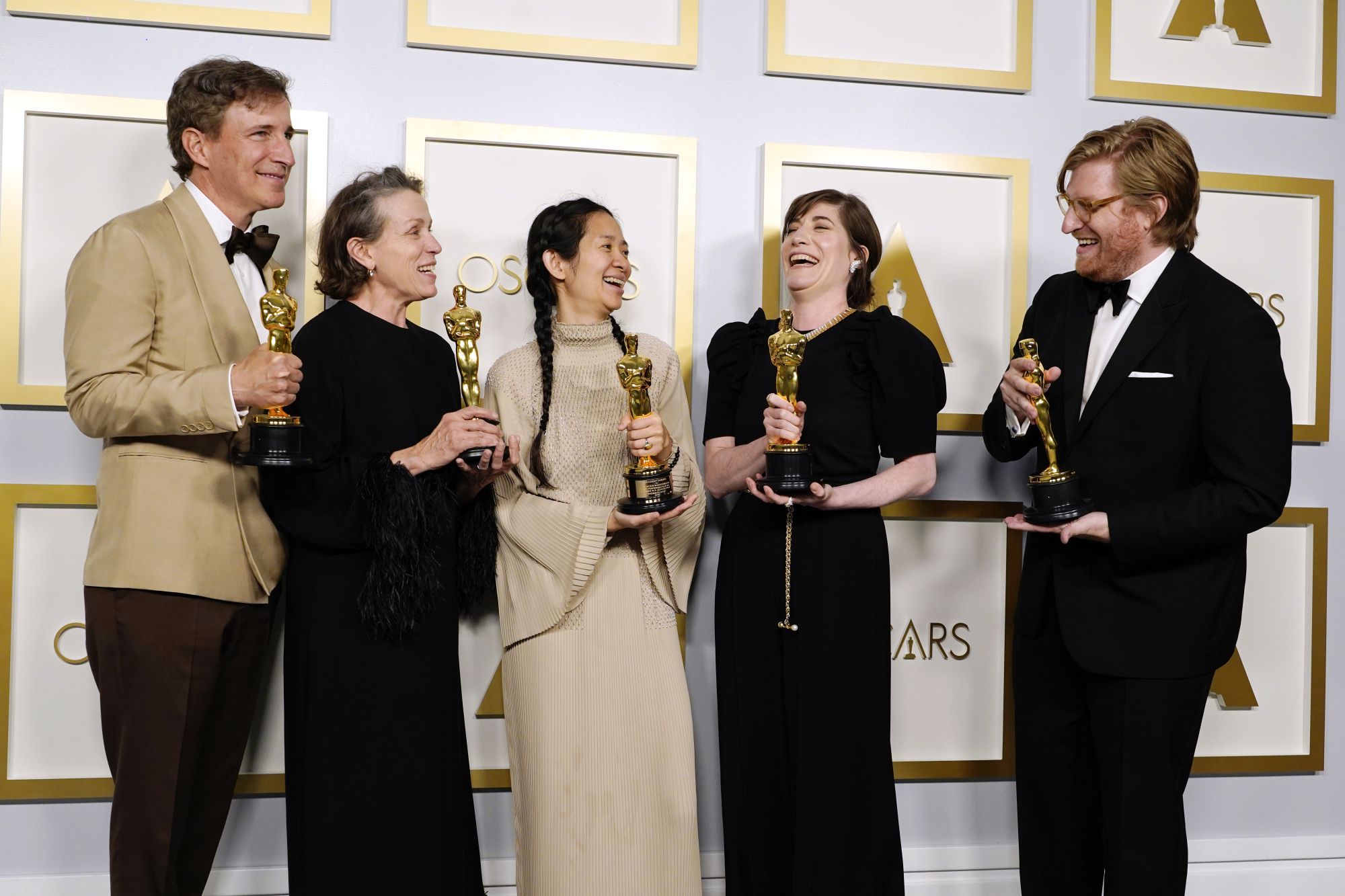 LOS ANGELES, CALIFORNIA - APRIL 25: (L-R) Peter Spears, Frances McDormand, Chloe Zhao, Mollye Asher, and Dan Janvey, winners of Best Picture for "Nomadland," pose in the press room at the Oscars on Sunday, April 25, 2021, at Union Station in Los Angeles. (Photo by Chris Pizzello-Pool/Getty Images)