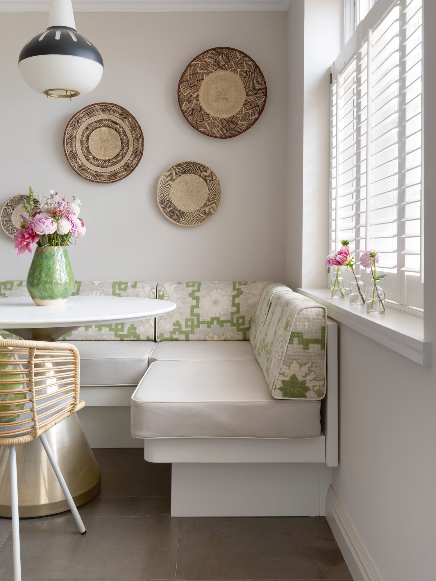 Hints of soft green and pink lend a welcoming air to this cosy nook