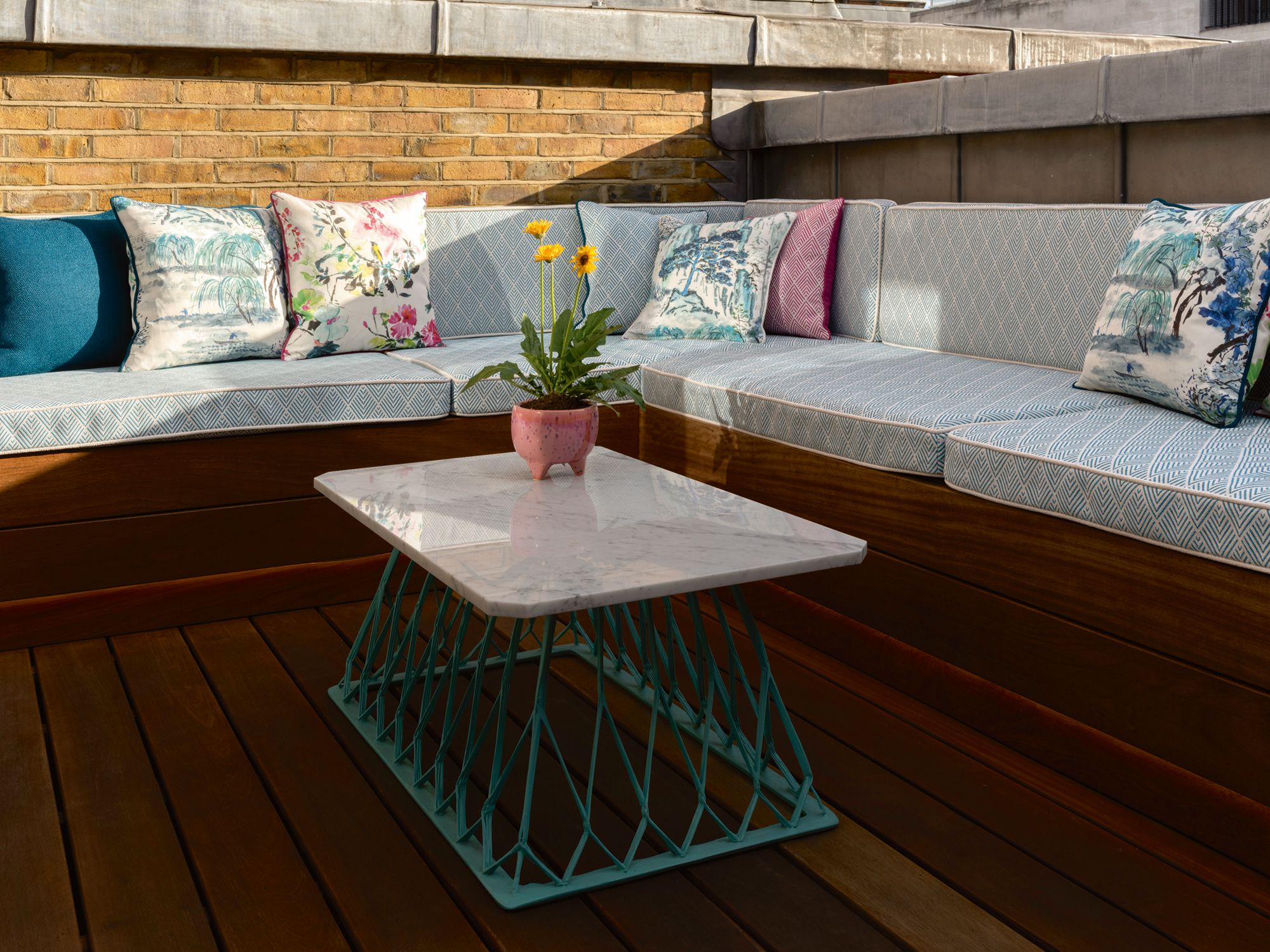 Floral cushions add a colourful touch to this outdoor area