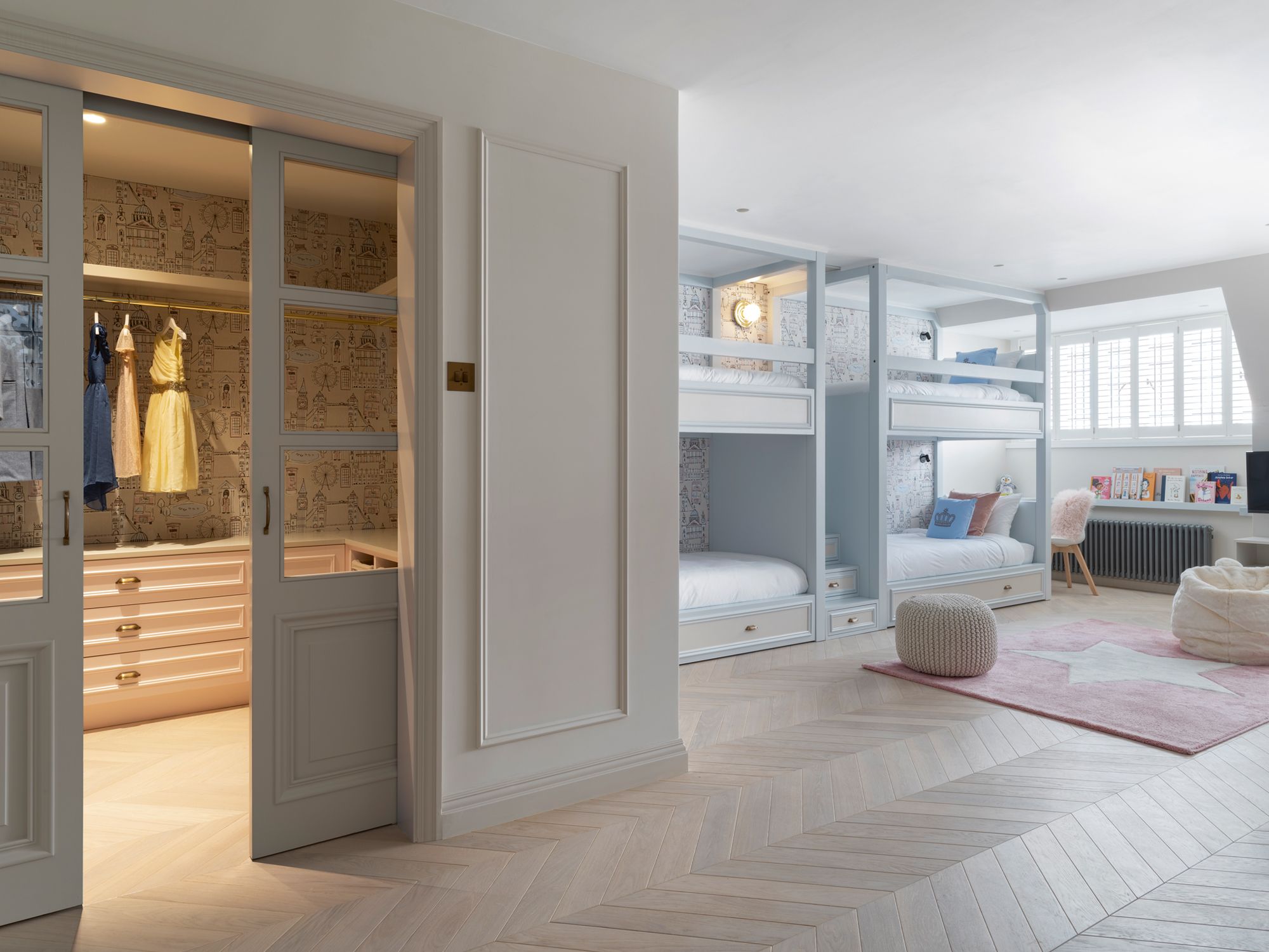 The grandchildren’s shared bedroom features bespoke wallpaper that depicts landmarks in London