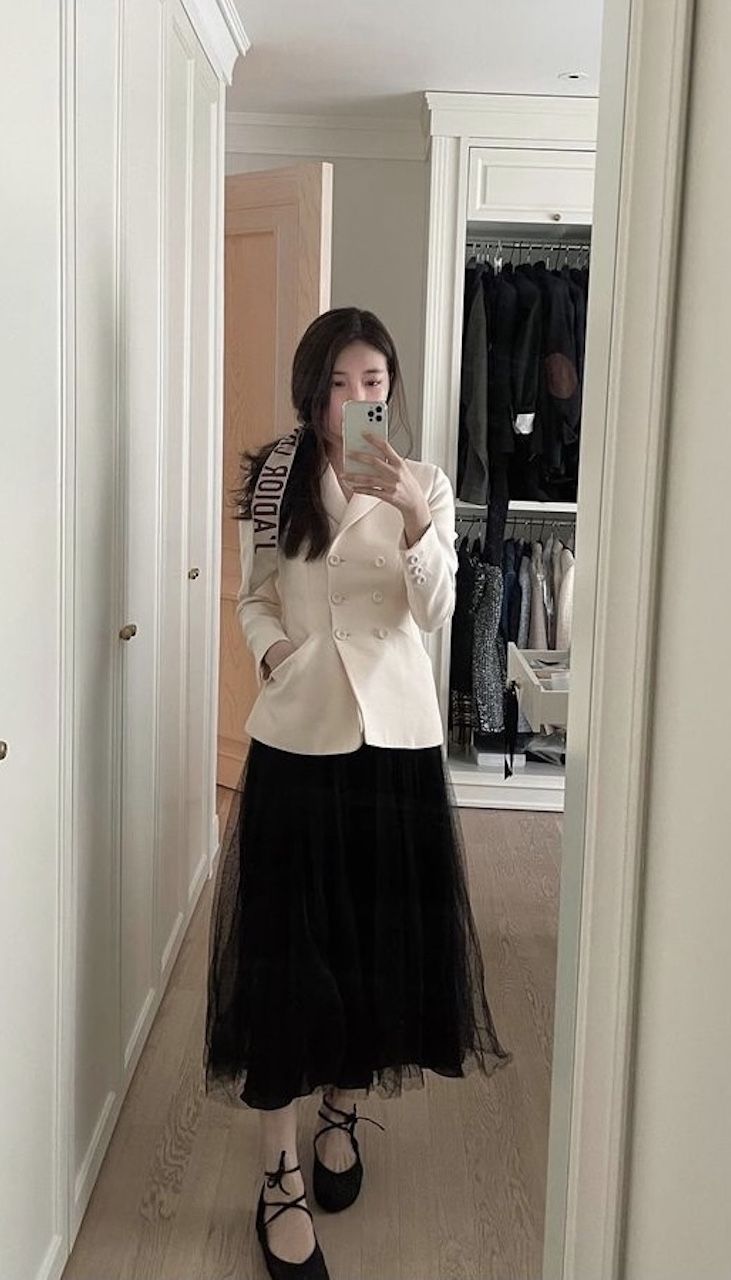 In a Dior jacket and tulle skirt.