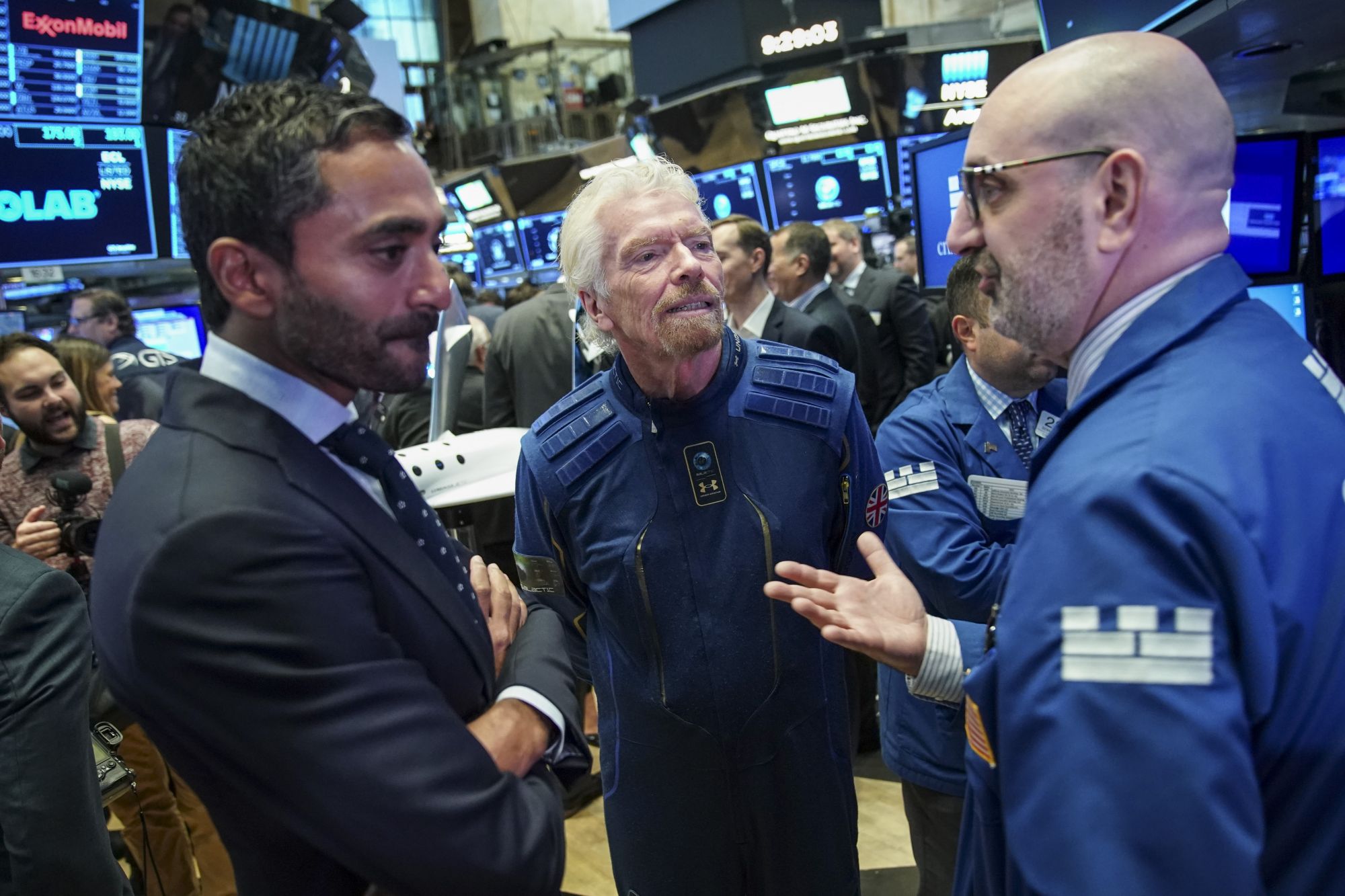 NEW YORK, NY - OCTOBER 28: Â Sir Richard Branson, Founder of Virgin Galactic, talks with a trader before ringing a ceremonial bell on the floor of the New York Stock Exchange (NYSE) to promote the first day of trading of Virgin Galactic Holdings shares on October 28, 2019 in New York City. Virgin Galactic Holdings became the first space-tourism company to go public as it began trading on Monday with a market value of about $1 billion. (Photo by Drew Angerer/Getty Images)