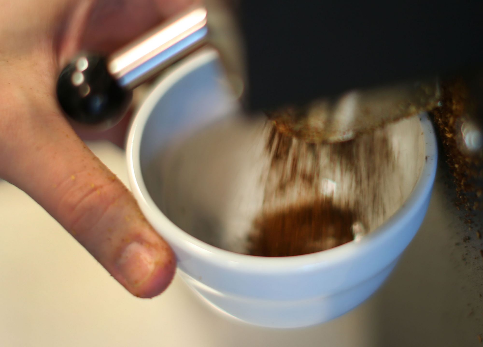 CANTON, MA - JANUARY 16: Coffee grounds fall into test cups. Helene Marsot is the coffee taster for Dunkin Donuts, her job is to taste the quality of the coffee from the beans that Dunkin buys from around the world. She works in a test kitchen at the corporate headquarters. (Photo by John Tlumacki/The Boston Globe via Getty Images)