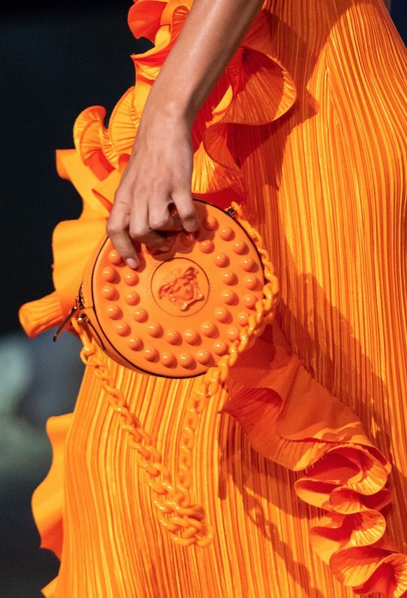 鑲飾圓形鉚釘圓形斜背小包 by Versace。