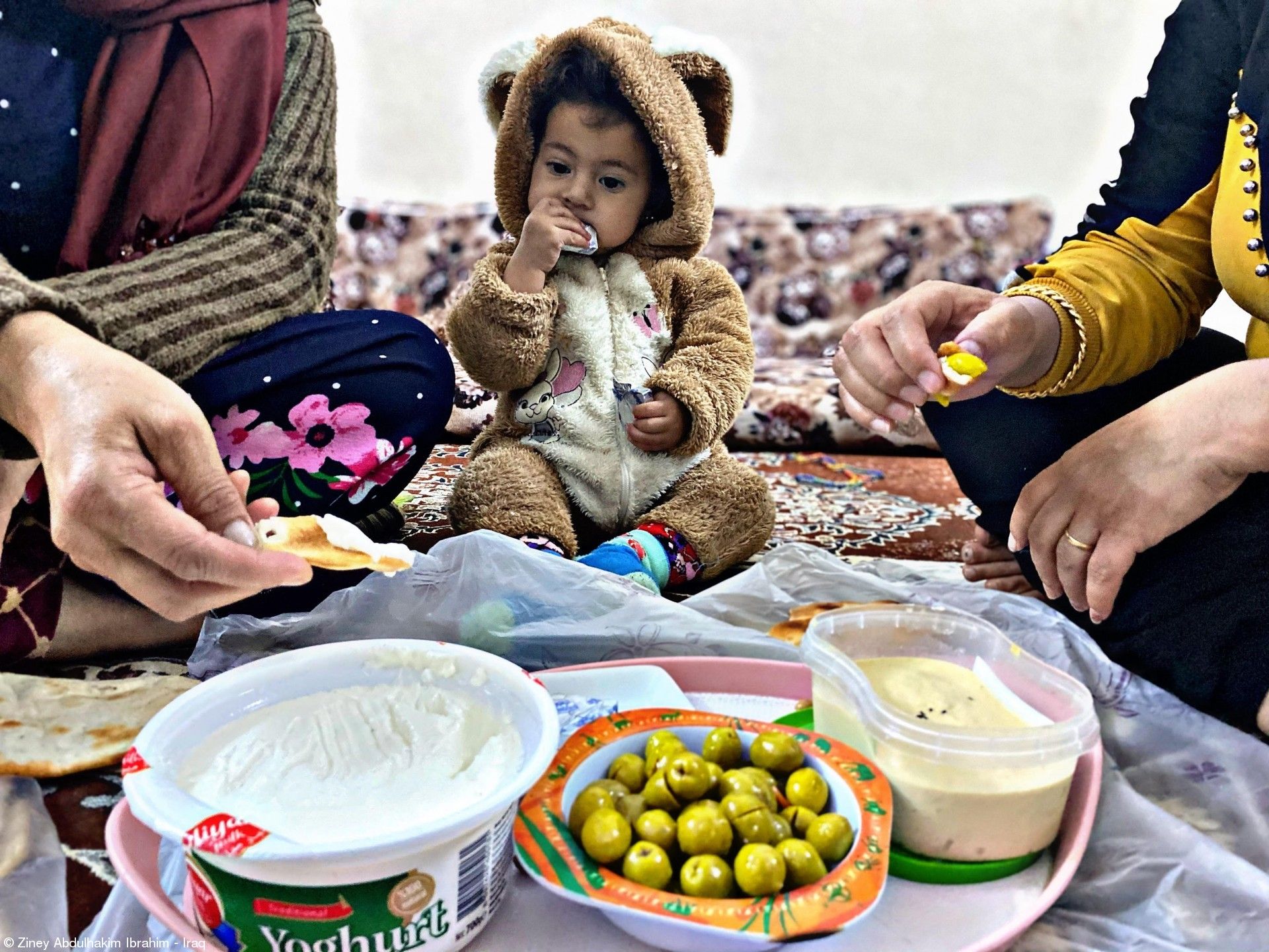 伊拉克攝影師紀錄下一家人圍坐用餐的畫面。Photograph: Ziney Abdulhakim Ibrahim