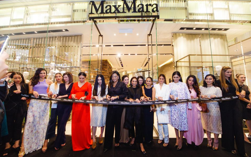 All the ladies dressed in Max Mara line up for the ribbon cutting ceremony