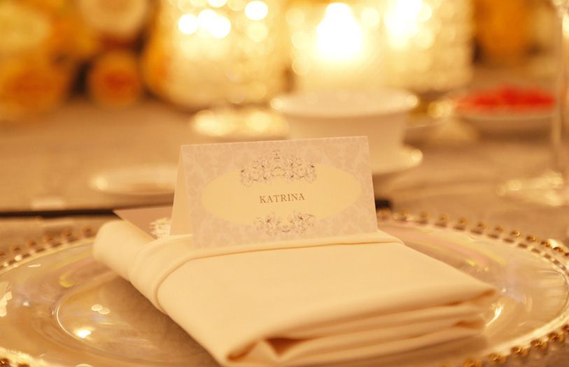 The grand ballroom was a glamorous yellow and silver mirage of candles, glittering chandeliers, fine china and bouquets upon bouquets of vibrant flowers.