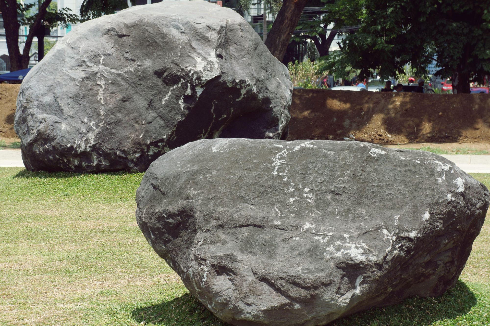 Outside the Kalaw entrance of the building lies huge Mayon Volcano boulders on display.