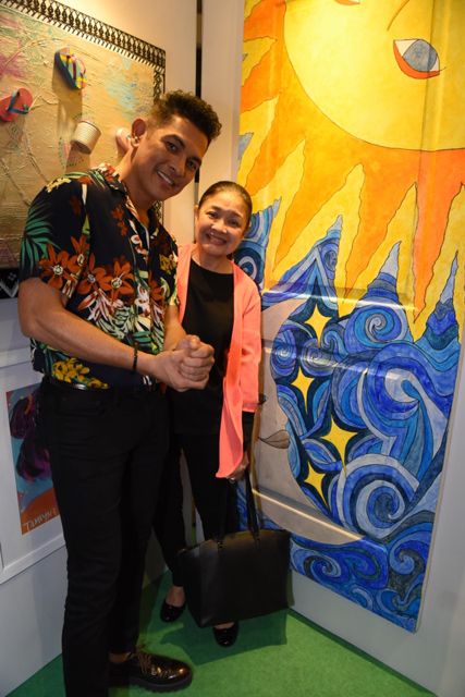 Gary Valenciano and Angeli Pangilinan Valenciano strike a pose beside Kiana Valenciano’s door artwork entitled Sun & Moon.